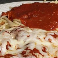 Eggplant Parmigiana · Fresh slices of eggplant, lightly breaded and sauteed. Baked in marinara sauce and topped wi...