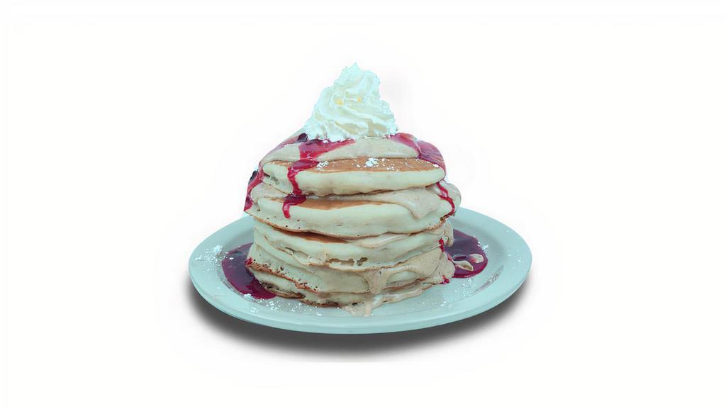 Ny Cheesecake Pancakes · Buttermilk pancakes filled with cream cheese. Topped with strawberry glaze, whipped cream, and powdered sugar.
