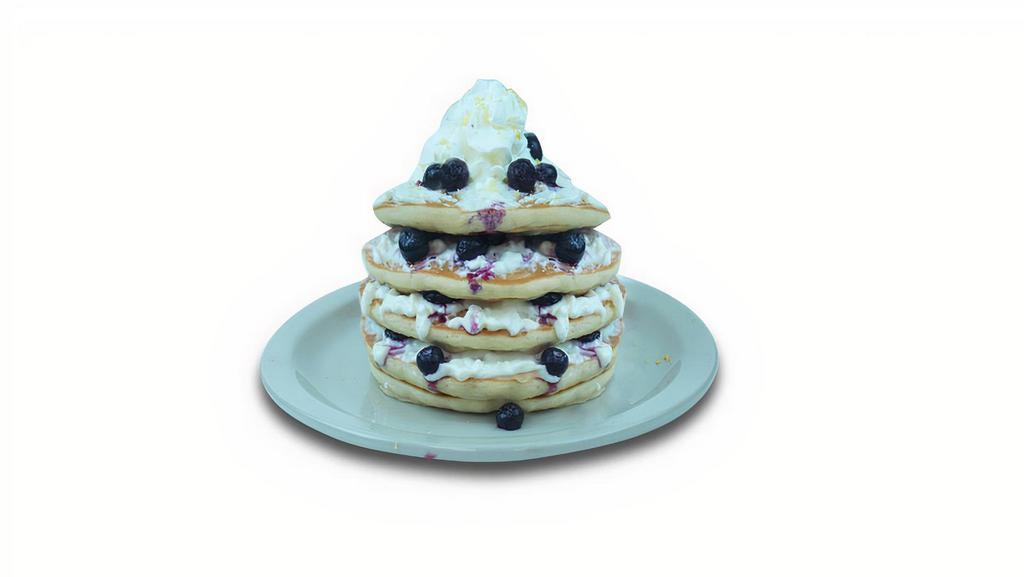 Lemon Ricotta Blueberry Pancakes · Buttermilk pancakes filled with blueberries, layered with lemon-flavored ricotta. Topped with whipped cream.