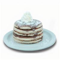 Cinnamon Pancakes · Buttermilk pancakes layered with Cinnamon. Topped with whipped cream, and powdered sugar.