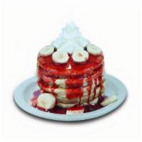 Strawberry Banana Pancakes · Buttermilk pancakes filled with fresh cut bananas. Topped with strawberry glaze, fresh cut b...