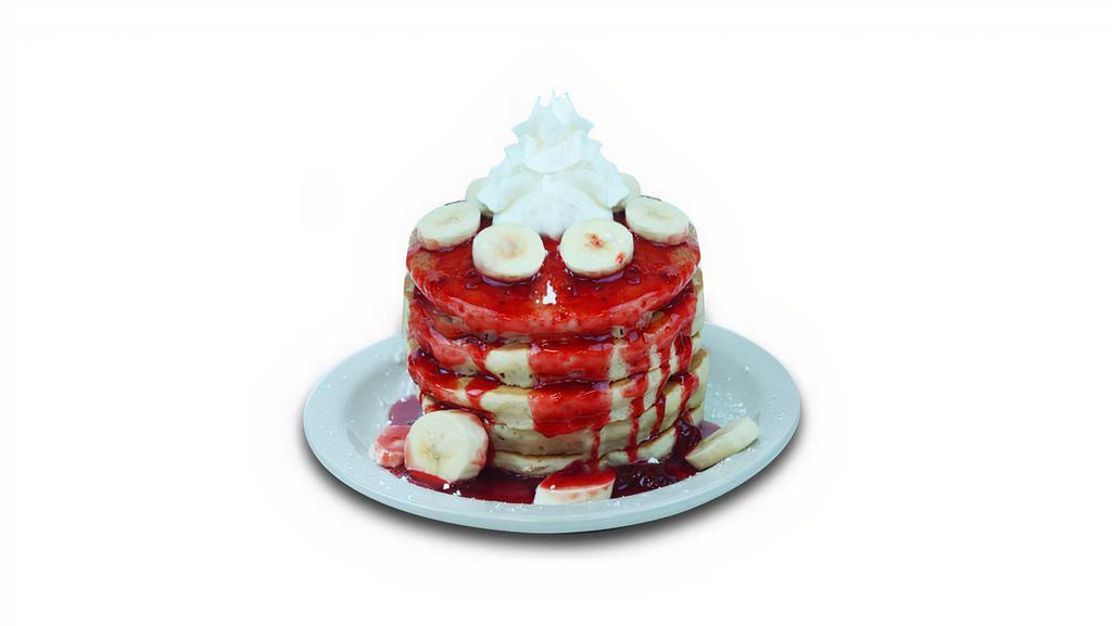 Strawberry Banana Pancakes · Buttermilk pancakes filled with fresh cut bananas. Topped with strawberry glaze, fresh cut bananas, whipped cream, and powdered sugar.