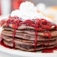 Strawberry Chocolate · Chocolate pancakes filled with chocolate chips. Topped with our strawberry glaze, whipped cr...