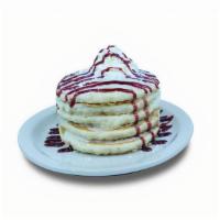 Raspberry Pancakes · Buttermilk pancakes layered with raspberry icing. Topped with powdered sugar, whipped cream,...