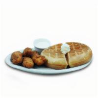Chicken & Waffle · Four buttermilk crispy fried chicken strips with a Belgian Waffle. Served with a side of hon...