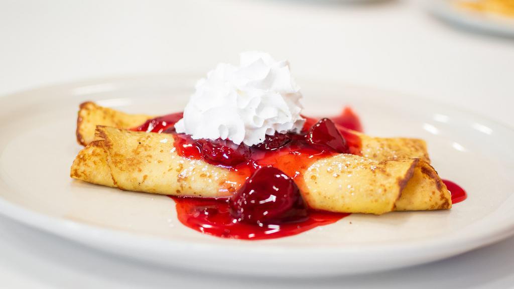 Strawberry Creme Cheese Crepes · Crepes filled with strawberry cream cheese, topped with strawberry glaze and whipped cream.