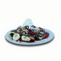 Nutella Crepes · Crepes filled with Nutella® spread, topped with bananas, strawberry glaze, and whipped cream.