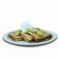 Banana Foster French Toast · French Toast topped with banana slices and whipped cream covered in sweet caramel sauce.