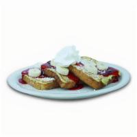 Strawberry Banana French Toast · French toast topped with fresh bananas, strawberry glaze and whipped cream.