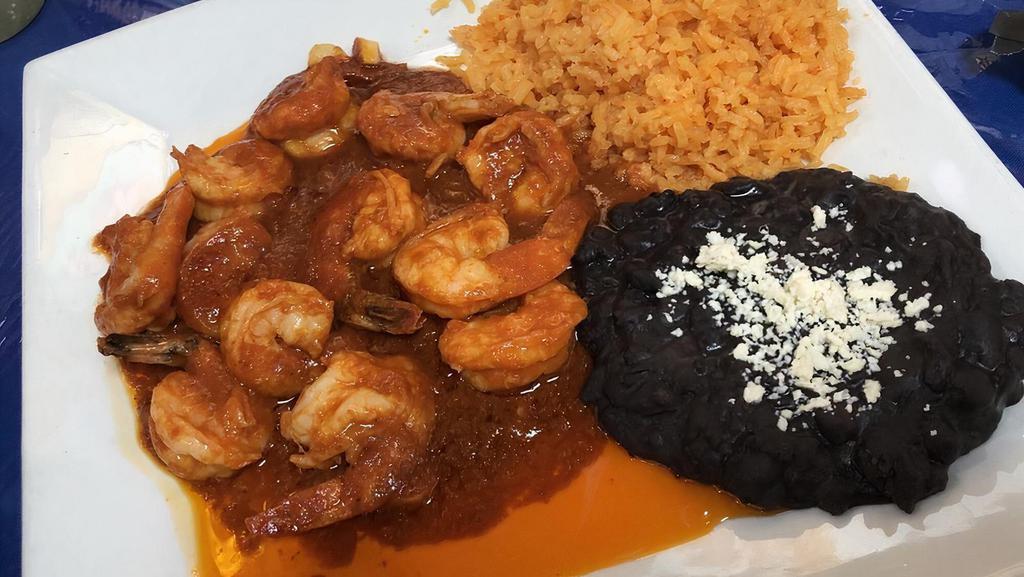 Camarones A La Diablo · Garlic shrimp sauteed on spicy red sauce served with rice and beans.