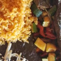 Churrasco Steak · Skin steak marinated on homemade chimichurri sauce. Served over grilled veggies, rice and be...