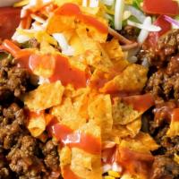 Taco Salad · A flaky, flour tortilla basket lined with refried beans, heaped with your choice of chicken,...