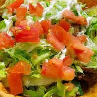 Fajita Taco Salad · Your choice of steak or grilled chicken, grilled onions and peppers, served on a crispy flou...