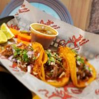 4 Tacos De Birria · Beef tacos with onions, cilantro, cheese, limes and a side of 