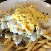 The Hangover Cure · French fries, turkey sausage, cheddar cheese, and 2 eggs your style topped with pepper gravy