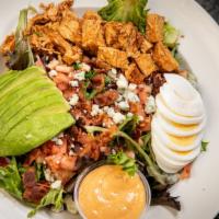 Company Cobb · Roasted chicken, bacon, avocado, tomatoes, hard boiled egg, and blue cheese on a bed of mixe...