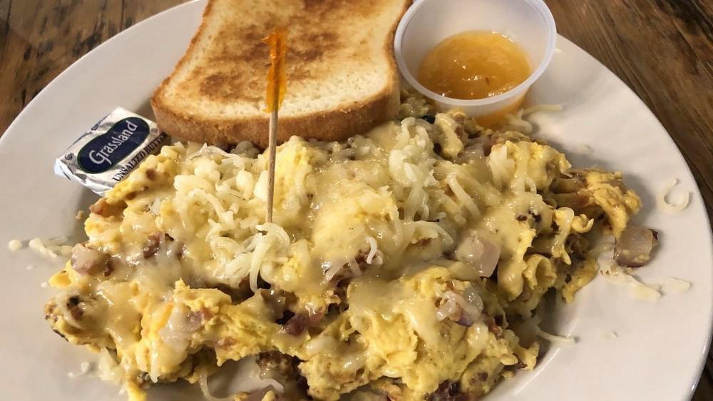 Local Farmer Scramble · An egg scramble filled with bacon, mushrooms, onions, and cheddar cheese. Served with a side of salsa and a slice of sourdough toast.