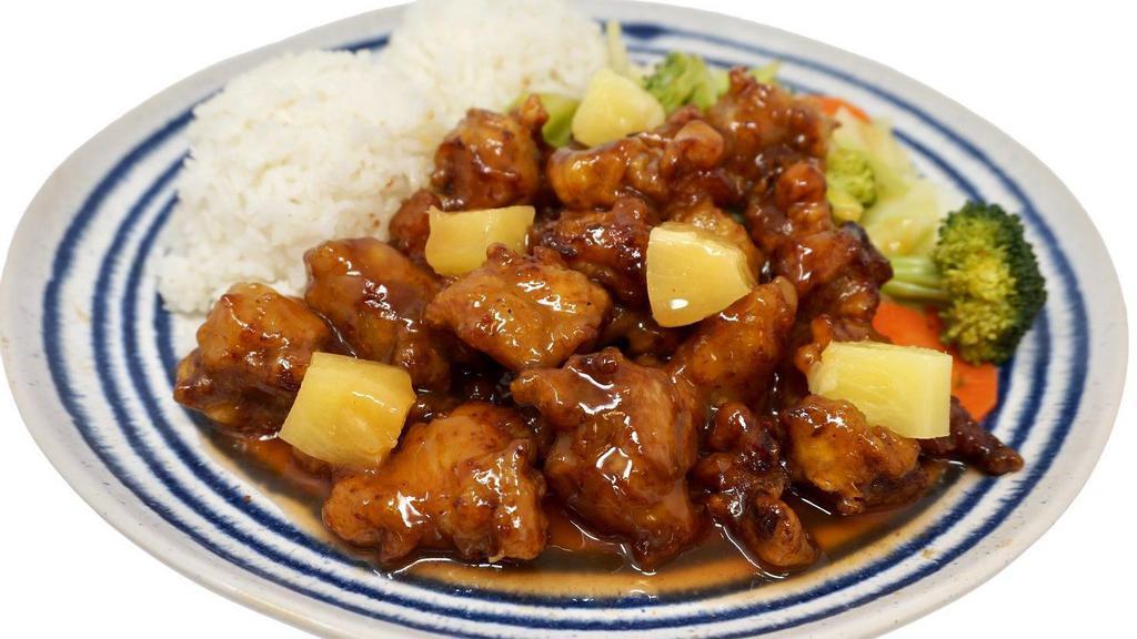 Sweet And Sour Chicken · Crispy, deep-fried chicken topped with sweet and sour sauce and pineapple chunks. Comes with two scoops of steamed rice and steamed vegetables.