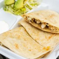 Quesadillas · Flour tortilla cheese and meat of your choice 
Salad and cream