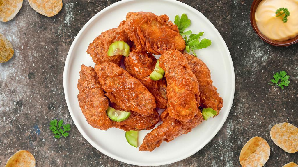 Hot Wings · Fresh chicken wings breaded, fried until golden brown, and tossed in hot sauce. Served with a side of ranch or bleu cheese.