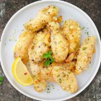 Boneless Garlic Parmesan Wings · Fresh boneless  chicken wings breaded, fried until golden brown, and tossed in garlic and pa...
