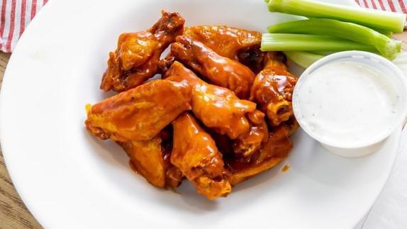 Buffalo Wings · Naked chicken wings, fried then tossed in buffalo sauce.