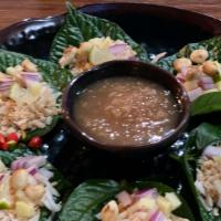 Miang Kham (6) · Fresh Cha Pu leaves that are filled with roasted coconut, red onion, fresh ginger, peanut an...