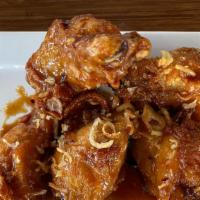Khao Yai Wings · Tossed in a slightly sweet tamarind sauce
