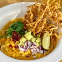 Khao Soi  · Northern Thai coconut curry noodles soup with chicken and rich creamy yellow curry, egg nood...