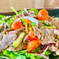 Yum Nua · Thai beef salad grilled for medium-high heat then sliced to mix spicy dressing sauce with mi...