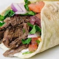 Beef Shawarma Wrap · Thin slices of marinated beef tahini sauce, pickles, tomatoes, sumac and onions