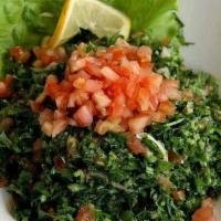 Tabouleh · Finley chopped parsley mixed with cracked wheat, tomatoes, cucumbers, onions and mint. Seaso...