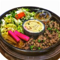 Beef Shawerma Bowl · Thinly sliced marinated beef served with rice, salad, hummus and pita bread.