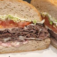 Hot Roast Beef* · Piled high with pickled red onion, lettuce, tomato, provolone, and red wine mayo served on h...