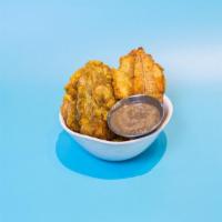 Tostones* · twice-fried mashed green plantains with mojo