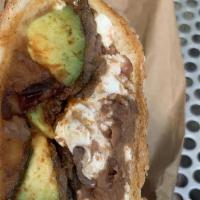 Cemita · Sesame seed bread with quesillo, chipotle, avocado, onions, papalo and filling.