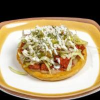 Sope · Small fried thick tortilla with refried beans, lettuce, homemade guacamole, cream, cheese an...