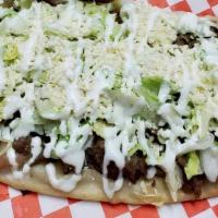 Huarache · Deep fried masa oblong shaped tortilla with refried beans, lettuce, homemade guacamole, crea...