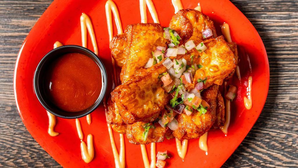 Queso Frito · Six fried cheese sticks with guava Sriracha sauce.