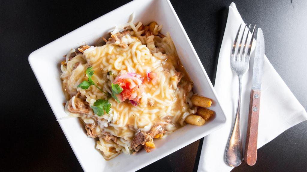 Lechon Disco Fries (Ah-May-Zing) · Fries topped with pemil, mozzarella cheese and pork gravy made from scratch.