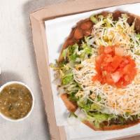 Tostada · Served with refried beans. Lettuce. Tomato and cheese.