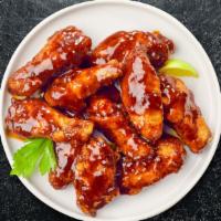 Bbq Boi Wings · Fresh chicken wings breaded, fried until golden brown, and tossed in barbecue sauce. Served ...