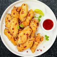 Illy Chili Wings · Fresh chicken wings breaded, fried until golden brown, and tossed in sweet chili sauce. Serv...