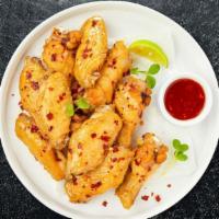 Spiced Bite Wings · Fresh chicken wings breaded, fried until golden brown, and tossed in spicy sauce. Served wit...