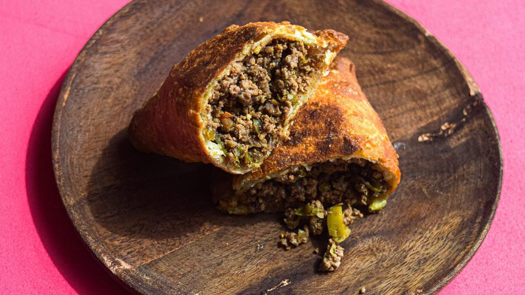 Picadillo Beef Empanada · Ground beef with a hint of cinnamon, spices, onions, raisins, diced olives.