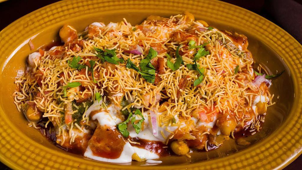 Samosa Chaat · Chopped Samosas topped with chickpeas and drenched in yogurt and chutneys