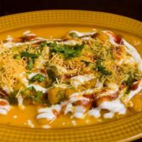 Ragda Patties · Pan-fried potato patties with a blanket of chickpeas drenched in yogurt and topped with chut...