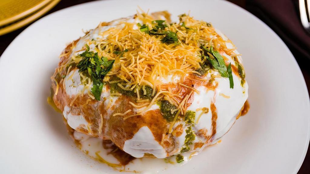 Raj Kachori Chaat · Round fried ball made of flour and dough filled with veg stuffing, covered with yogurt and chutnies.