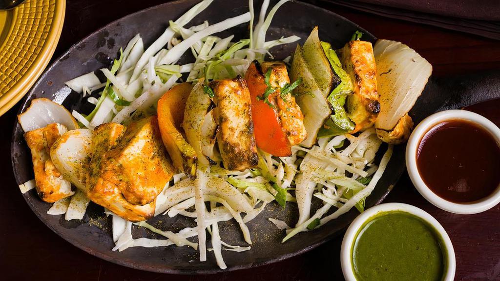 Paneer Bulandi Tikka · Paneer cheese marinated overnight,  skewered in tandoor oven served with roasted bell peppers and chutneys