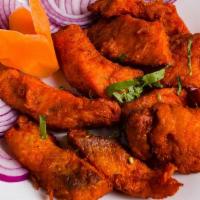 Amritsari Fish Pakora · Tilapia fish coated in house batter and deep-fried to a crispy consistency served with onion...